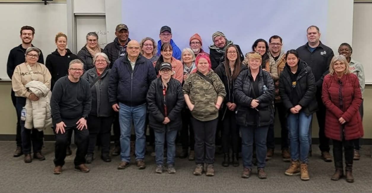 Group of community members posing together indoors after a gathering